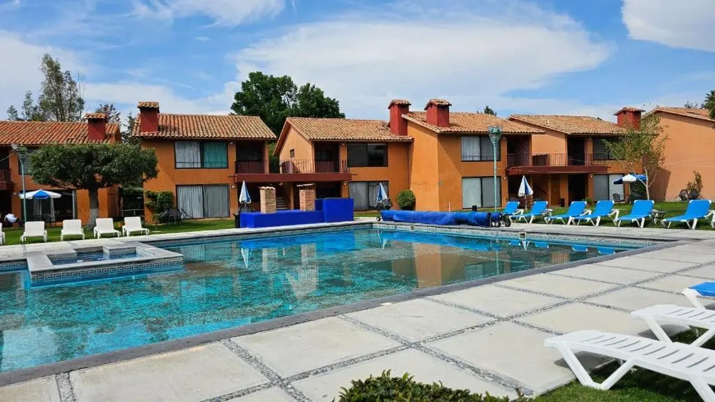 Outdoor swimming pool and terracotta villas at Hotel La Rinconada